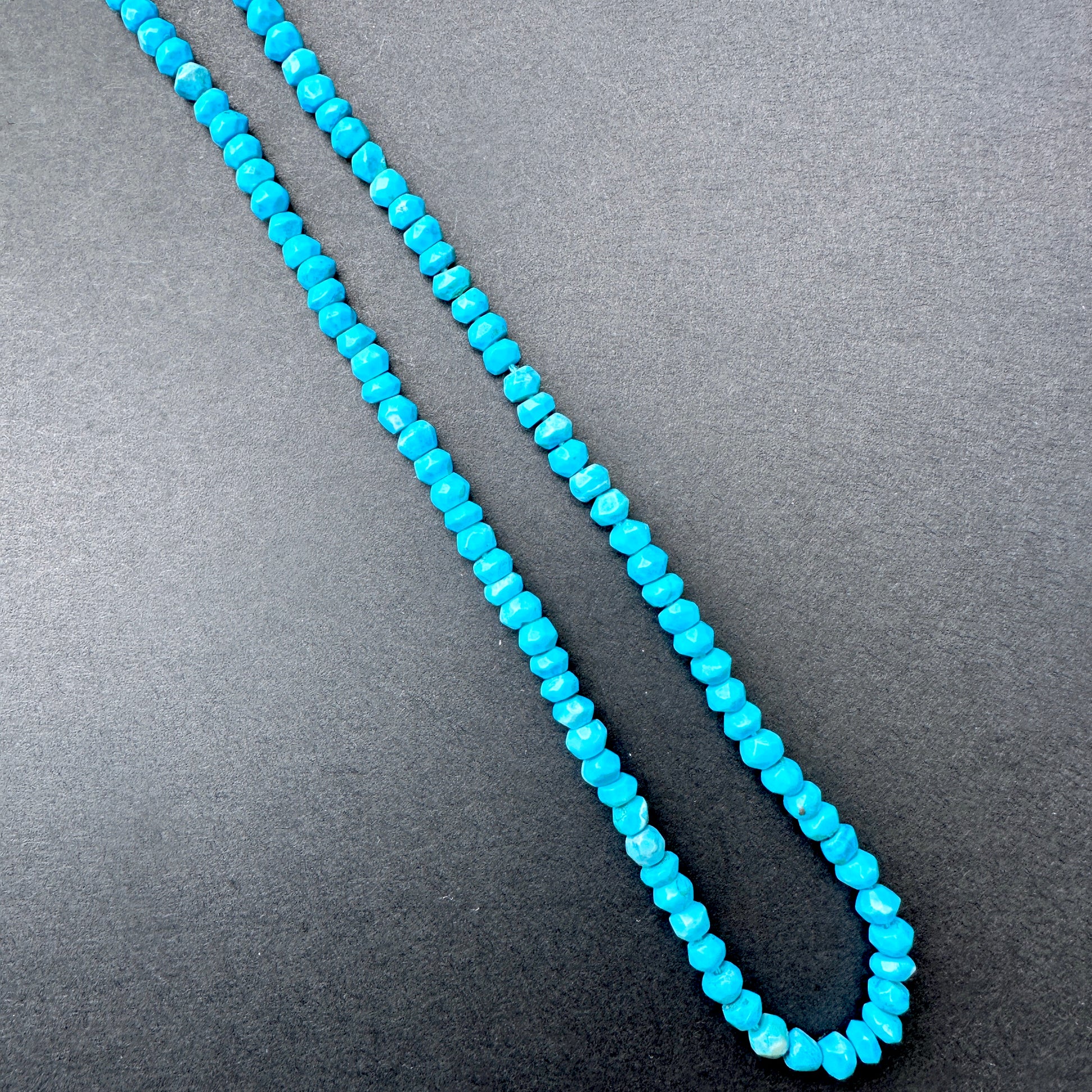 Delicate strands of Howlite Turquoise beads, showcasing their smooth design.