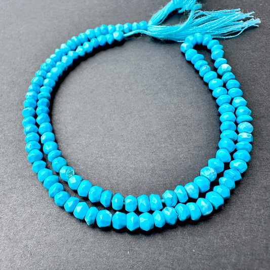 Howlite Turquoise faceted rondelle beads with bright turquoise tones and natural veining arranged on a 34cm strand for jewellery making.