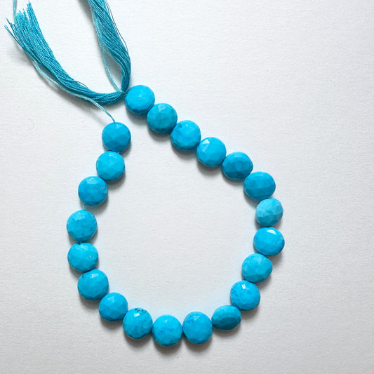 Close-up of Howlite Turquoise stone beads with faceted round cut and vibrant colour for handmade jewellery components.