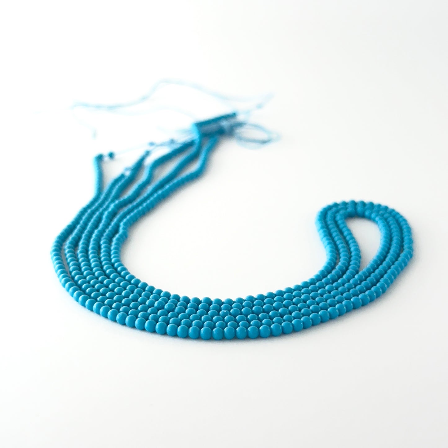 Howlite Turquoise smooth round gemstone beads showing soft turquoise‑blue tones and polished finish