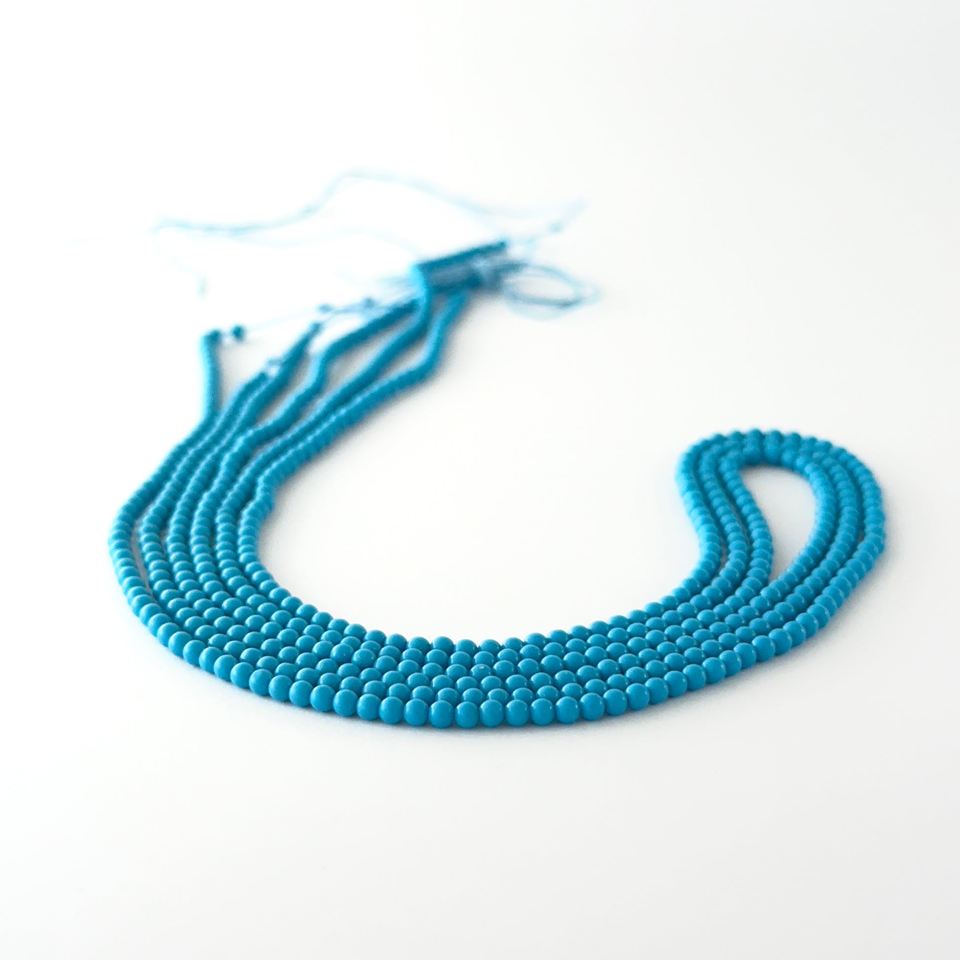 Howlite Turquoise smooth round gemstone beads showing soft turquoise‑blue tones and polished finish