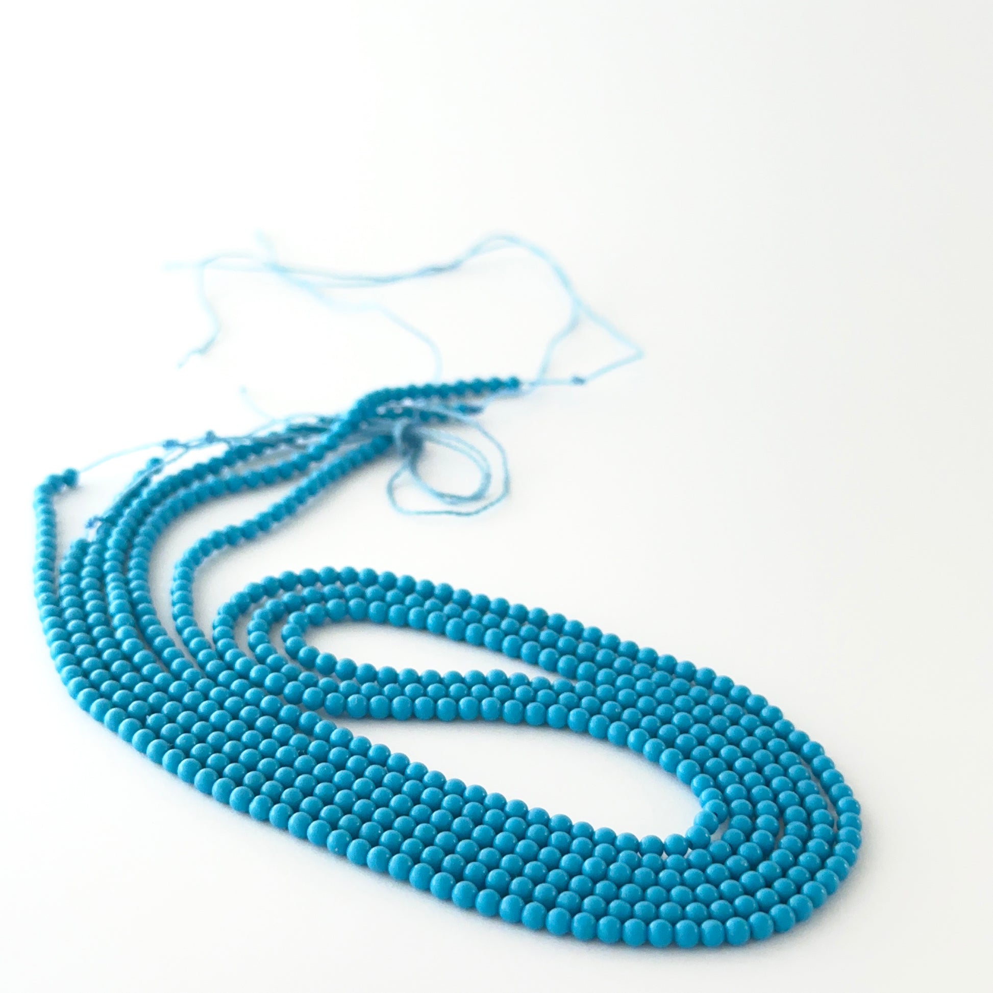 Close view of Howlite Turquoise smooth round beads showing clarity, proportions and premium gemstone quality.