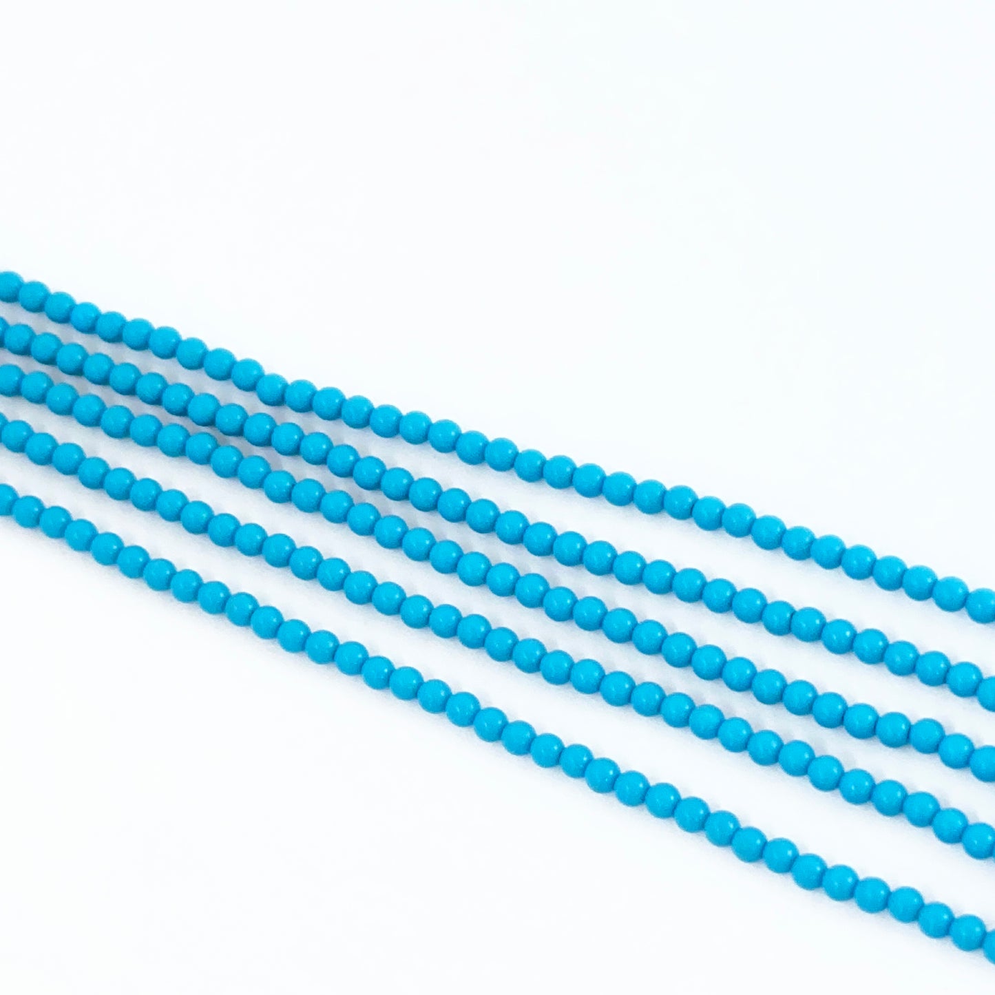 Stone beads made from Howlite Turquoise with soft blue hues and polished texture.