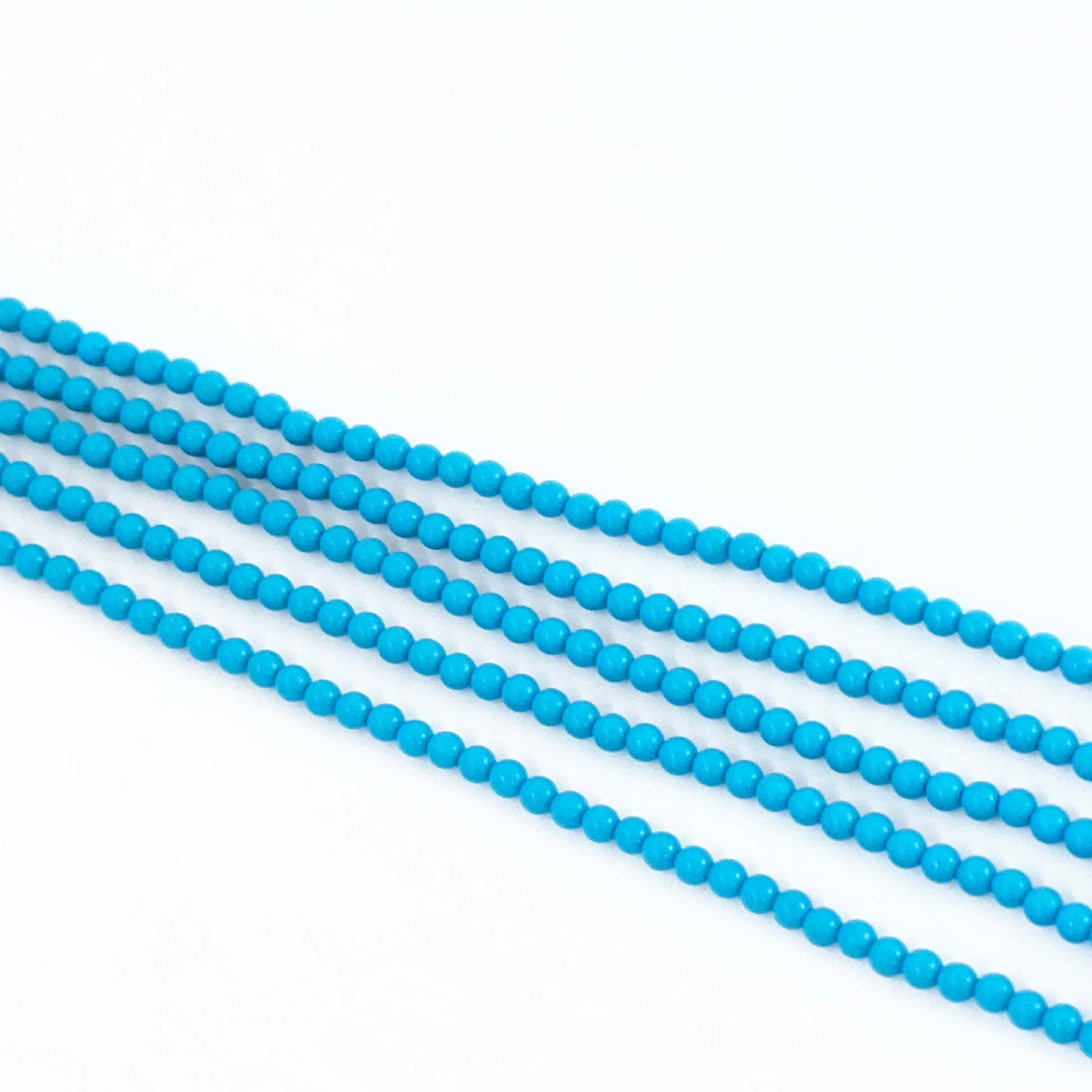 Stone beads made from Howlite Turquoise with soft blue hues and polished texture.