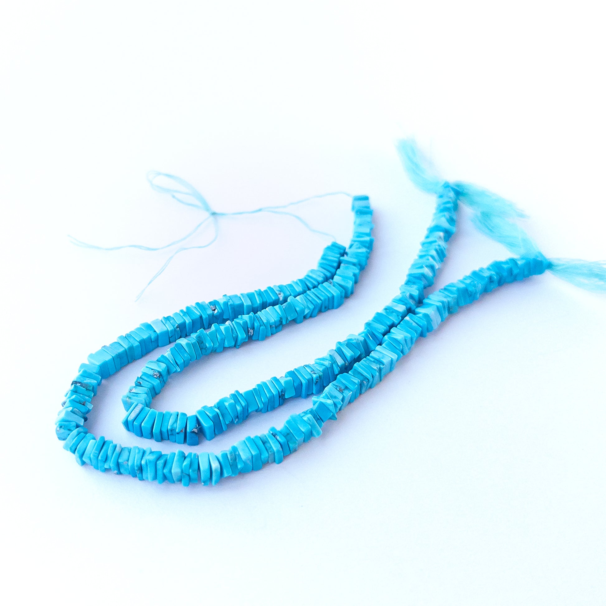 Authentic Howlite Turquoise gemstone beads showcasing clean cube‑like heishi cuts for handmade jewellery components.