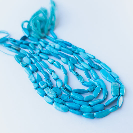 Howlite Turquoise smooth tumble gemstone beads in 5–7.5mm size arranged on a 32cm strand with soft blue tones.