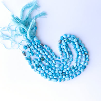 Howlite Turquoise smooth tumble beads in 6–6.5mm size on a 32cm strand, showcasing vibrant colour for handmade jewellery.