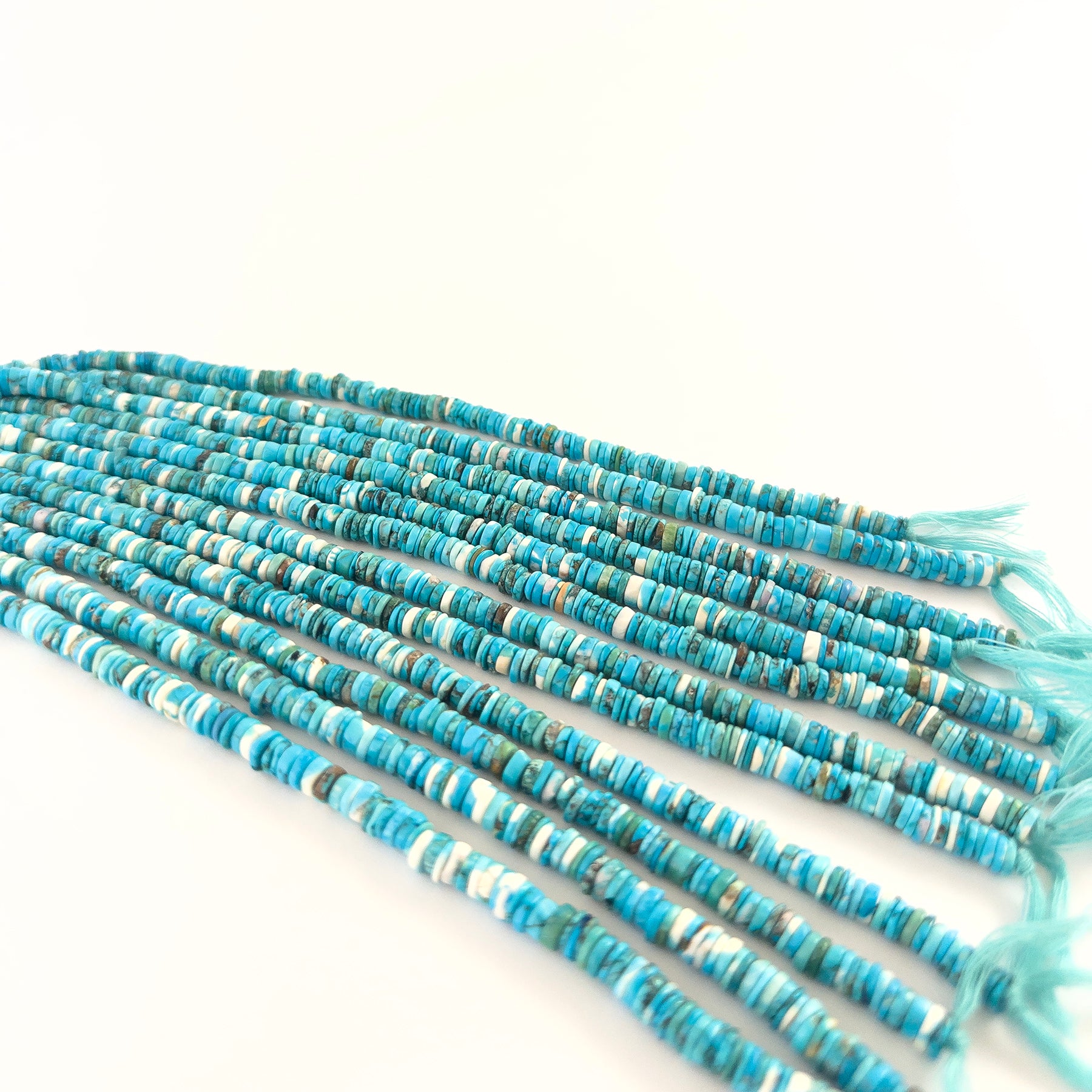Howlite Turquoise wheel beads featuring smooth surfaces and consistent 5–5.5mm sizing.
