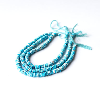 Close‑up of genuine Howlite Turquoise wheel heishi stone beads with clean shaping and vibrant blue tone.
