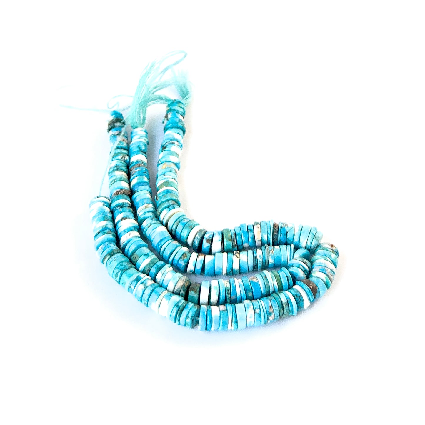 Authentic Howlite Turquoise gemstone beads arranged in a strand, highlighting their colour and polished texture