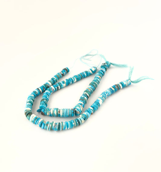 Howlite Turquoise smooth wheel heishi beads sized 6.5–7mm or 7.5–8mm arranged in a 20cm strand, showing bright turquoise‑blue colour and a polished finish.