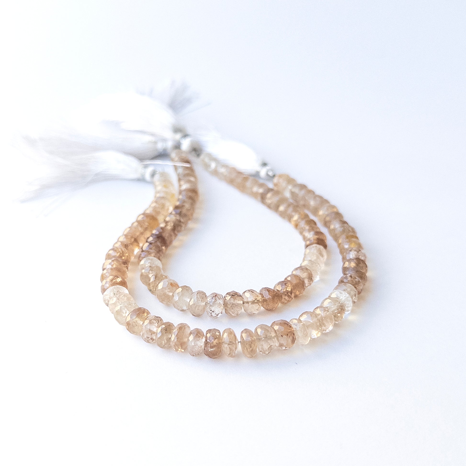 High‑quality Imperial Topaz rondelle beads arranged neatly for gemstone jewellery making.
