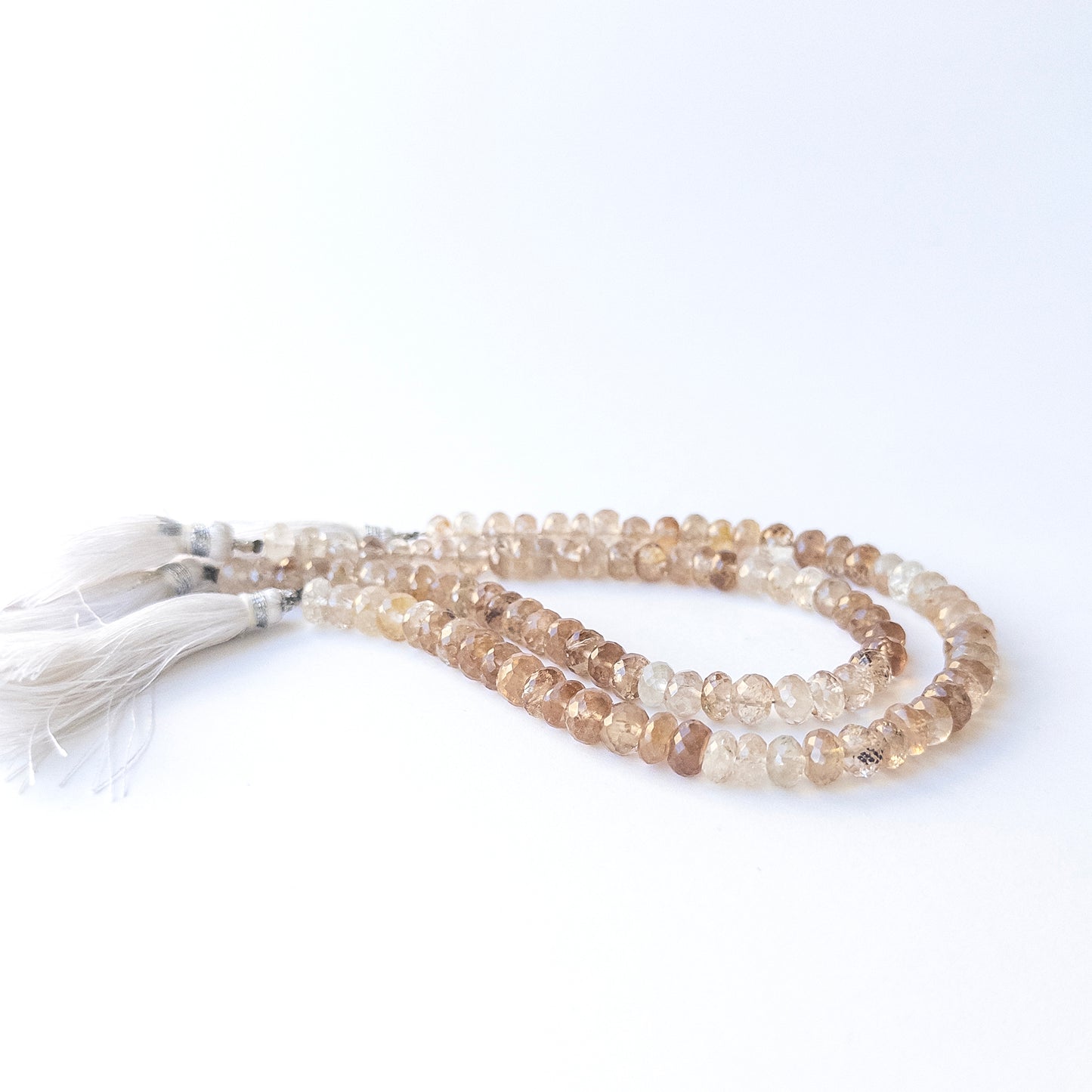 Delicate Imperial Topaz faceted rondelles showcasing brilliance and clarity for DIY gemstone designs.