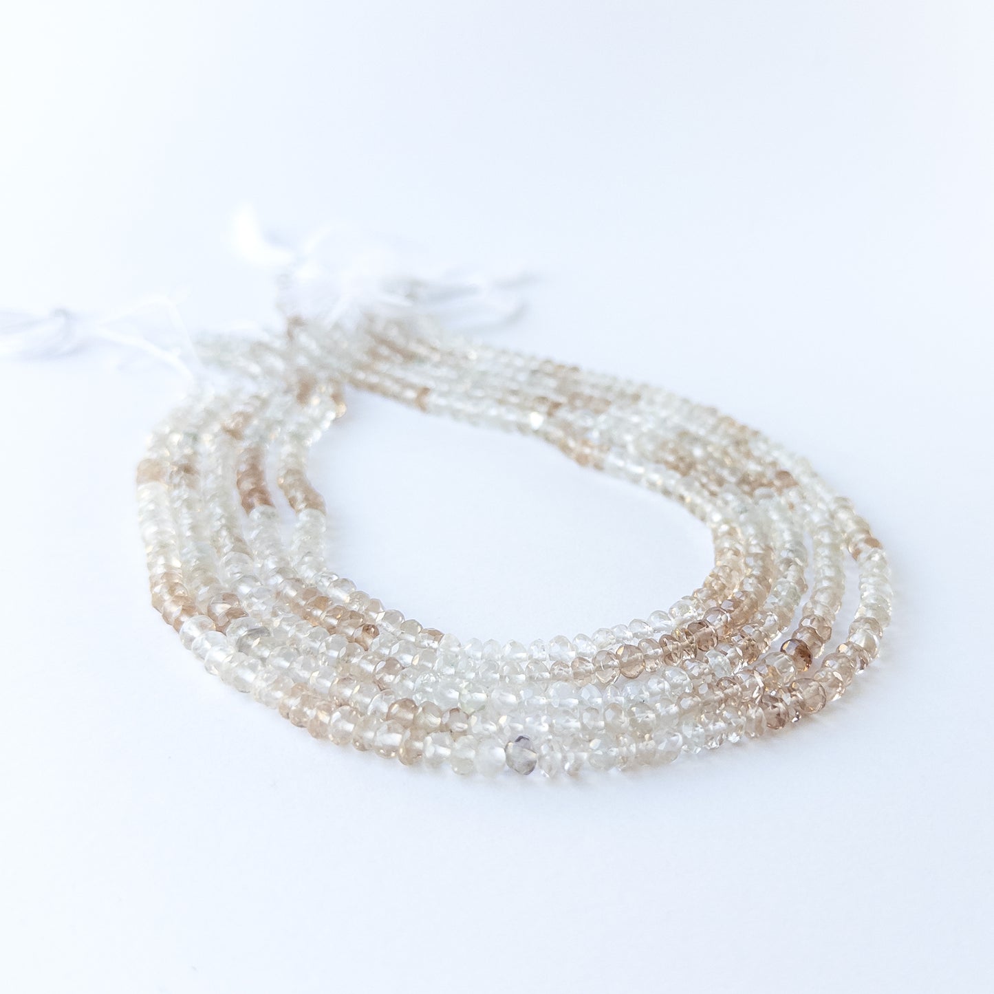 Close‑up of genuine Imperial White Topaz faceted rondelle beads showing bright facets and natural clarity.