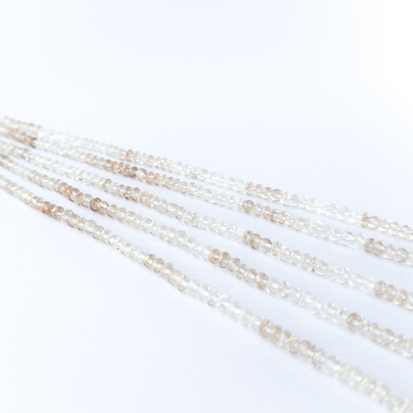 Imperial White Topaz rondelle beads showcasing natural shine and elegant faceting for gemstone bead creators.