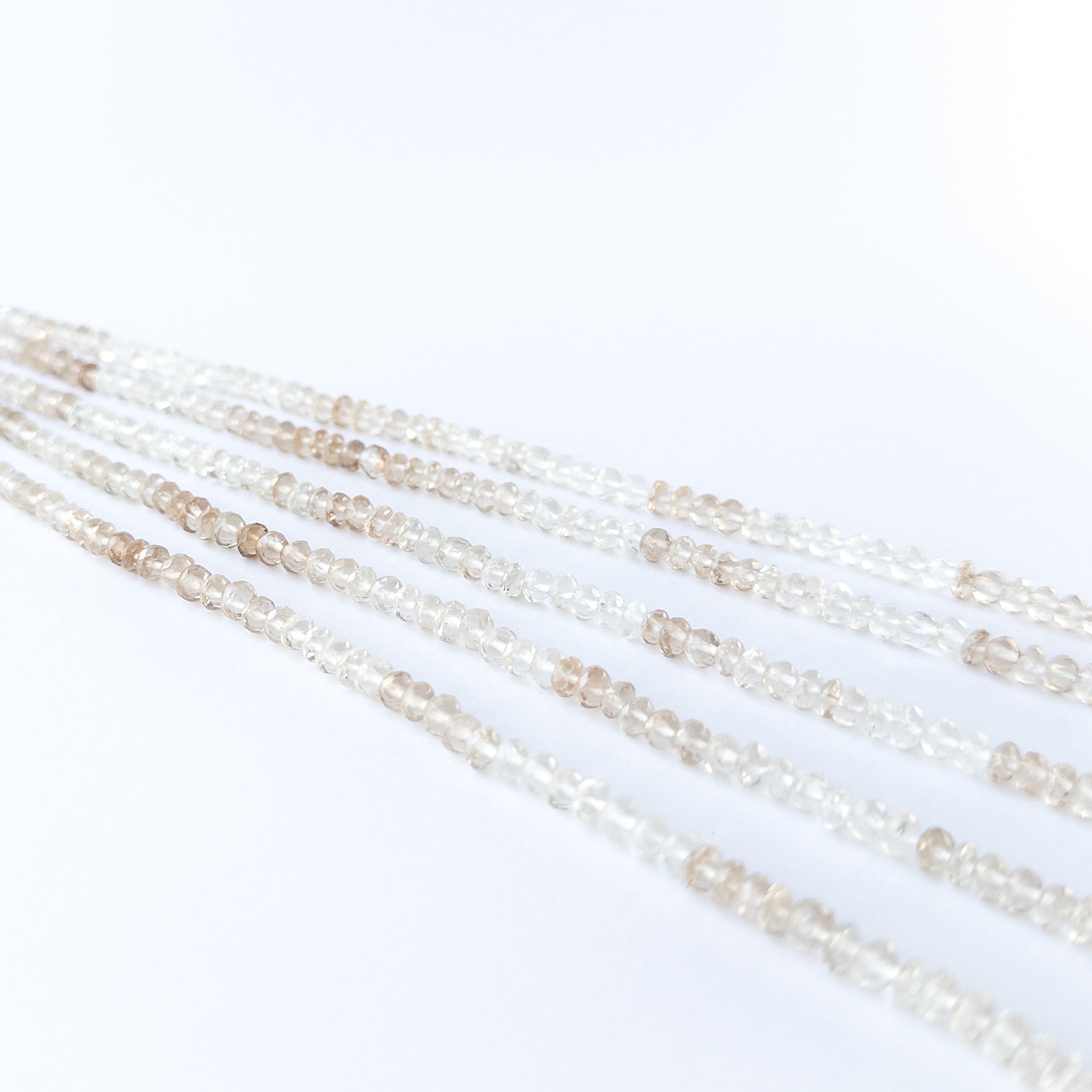 Imperial White Topaz rondelle beads showcasing natural shine and elegant faceting for gemstone bead creators.