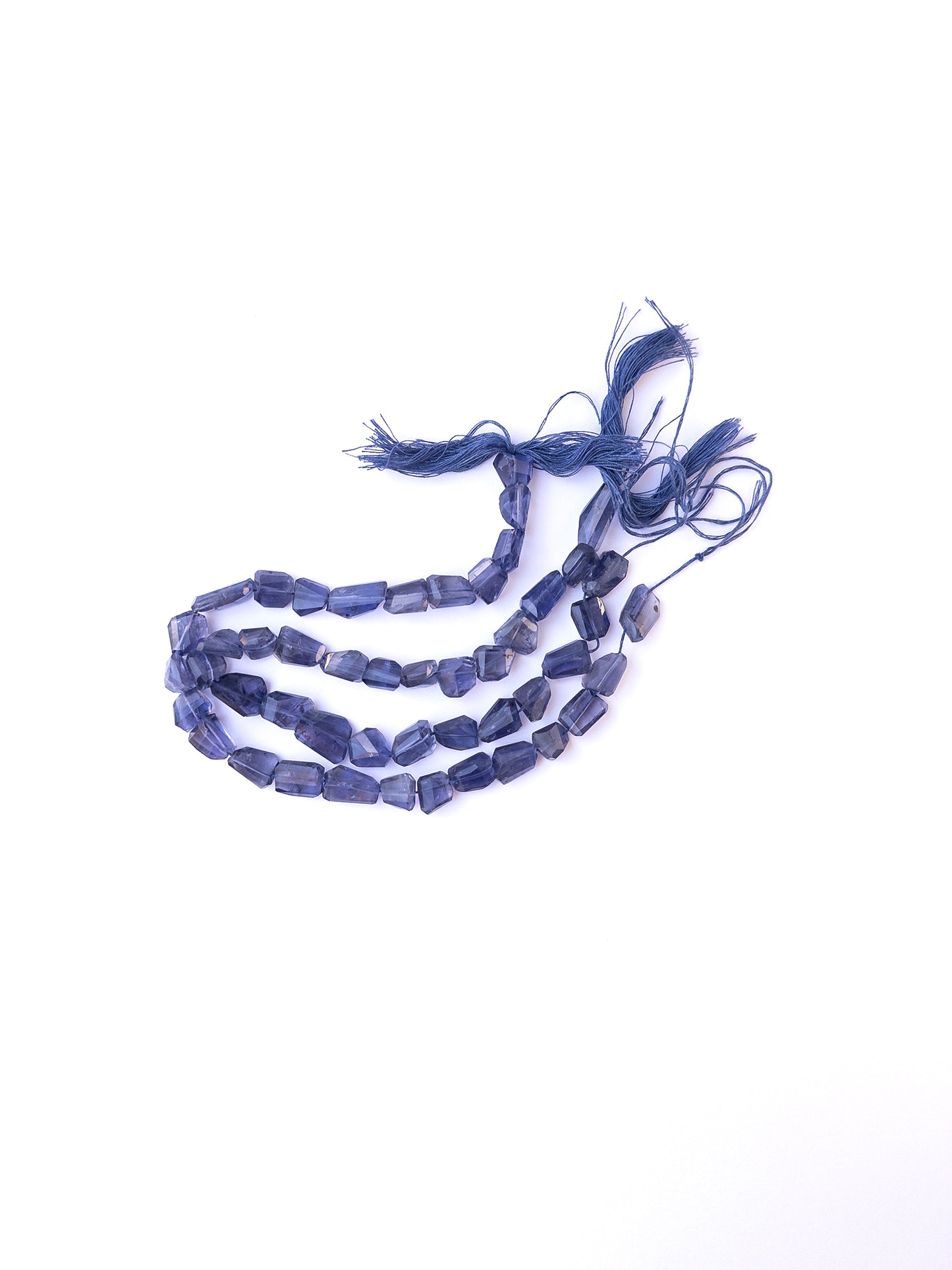 High‑quality iolite tumble gemstone beads with bright shine and natural colour variation on a long strand.