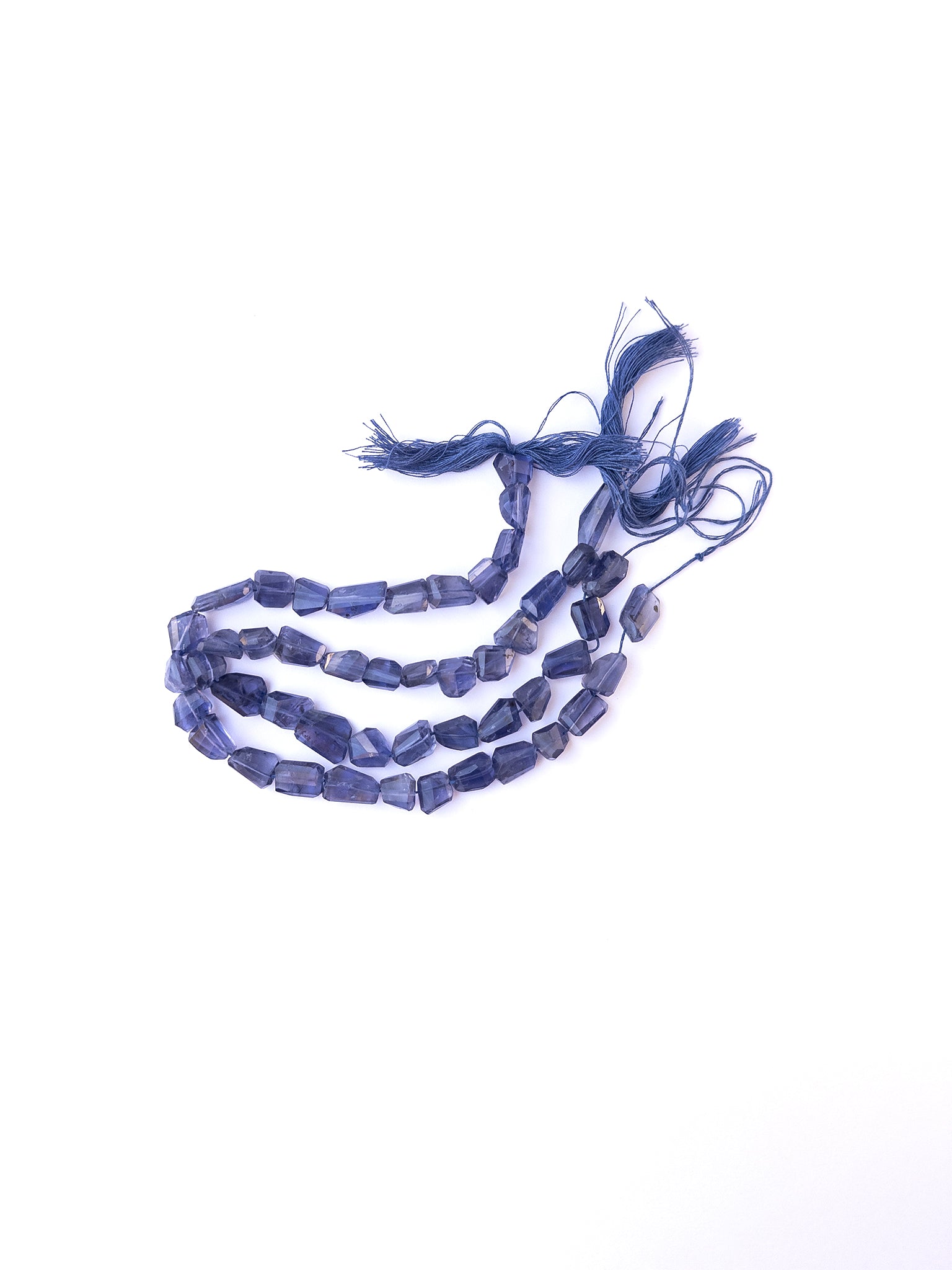 High‑quality iolite tumble gemstone beads with bright shine and natural colour variation on a long strand.
