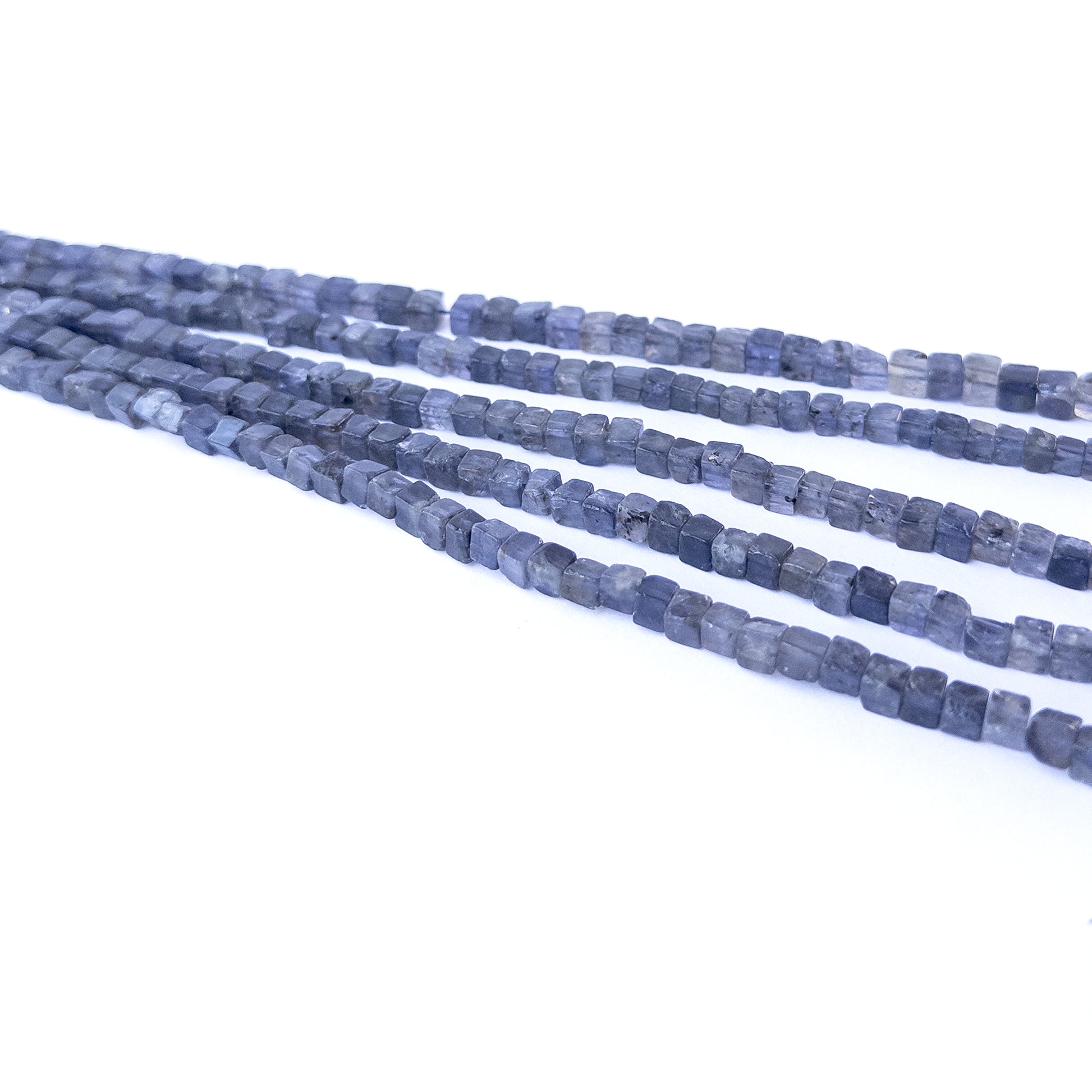 Iolite smooth cube gemstone beads in 4.5–5.3mm sizes arranged on a 20cm strand for jewellery making.
