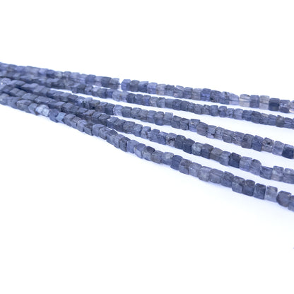 Iolite smooth cube gemstone beads in 4.5–5.3mm sizes arranged on a 20cm strand for jewellery making.