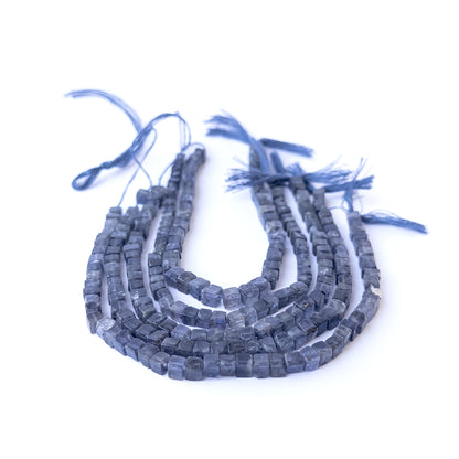 Genuine iolite stone beads with polished smooth cube shaping, ideal for DIY jewellery and artisan beadwork.