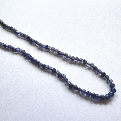 Stone beads with smooth Iolite arranged neatly, showcasing clarity and colour depth for handmade jewellery components.