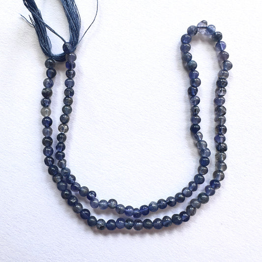 Smooth round Iolite beads in 3.5mm size with polished finish and deep blue-violet tones on a 30cm strand.