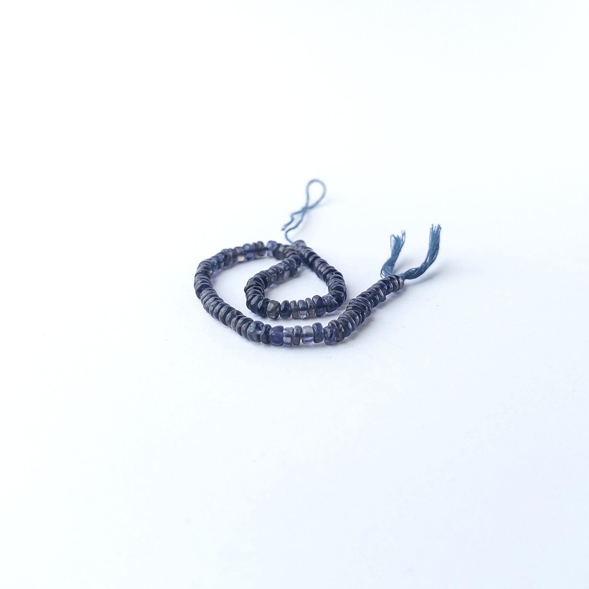 High‑quality Iolite smooth wheel beads in 4.3–4.7mm size offering clarity and shine for artisan jewellery projects.