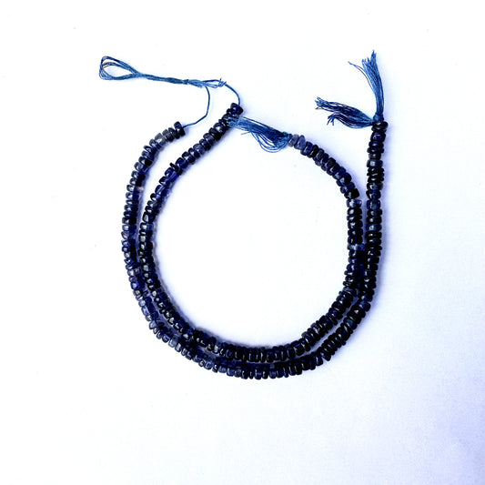 Smooth Iolite wheel beads with rich violet-blue colour and polished 4.7–5mm finish.