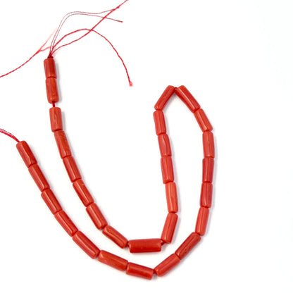Smooth Italian Coral cylinder beads showing rich colour and handmade jewellery component quality.