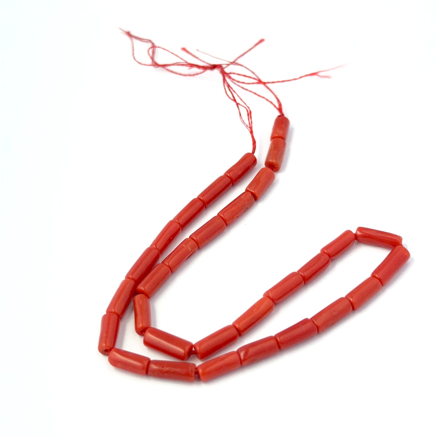 Stone beads for DIY jewellery featuring polished Italian Coral cylinders with consistent shape and shine.