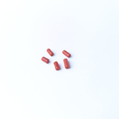 Shimmering Italian Coral beads with refined cylindrical shaping, genuine stone beads suited for detailed beadwork and crafting.