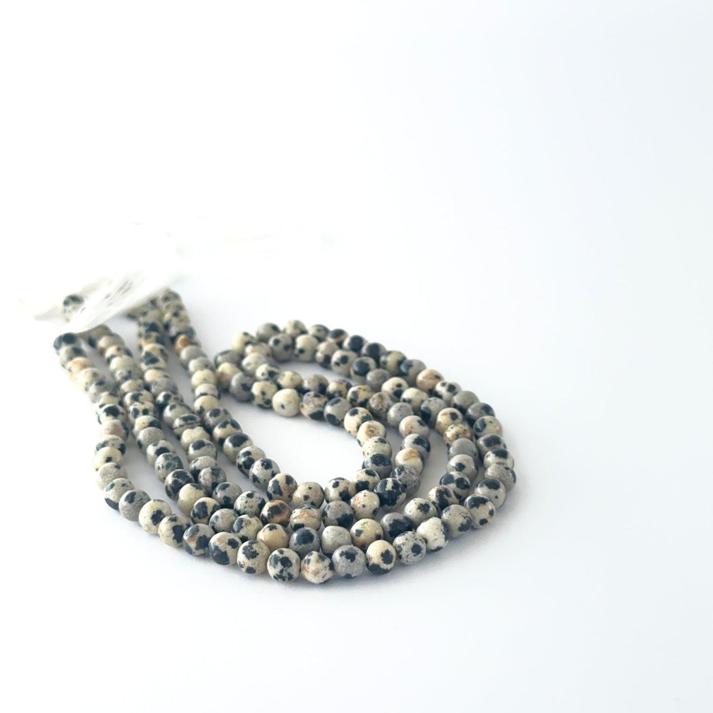 Smooth round Jasper beads arranged neatly, highlighting their glossy surface and handmade jewellery component quality.