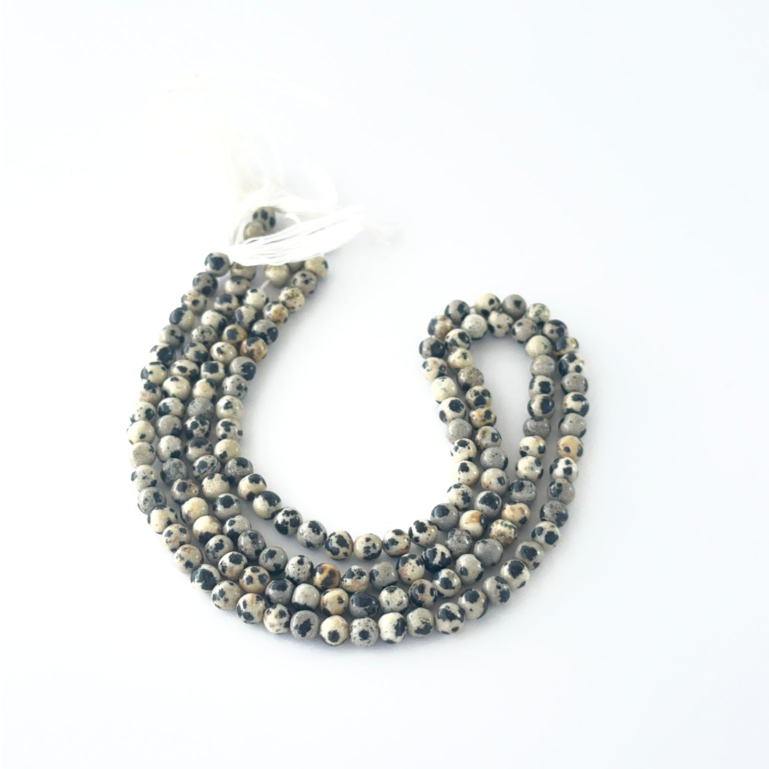 Smooth round Jasper beads arranged neatly, highlighting their glossy surface.