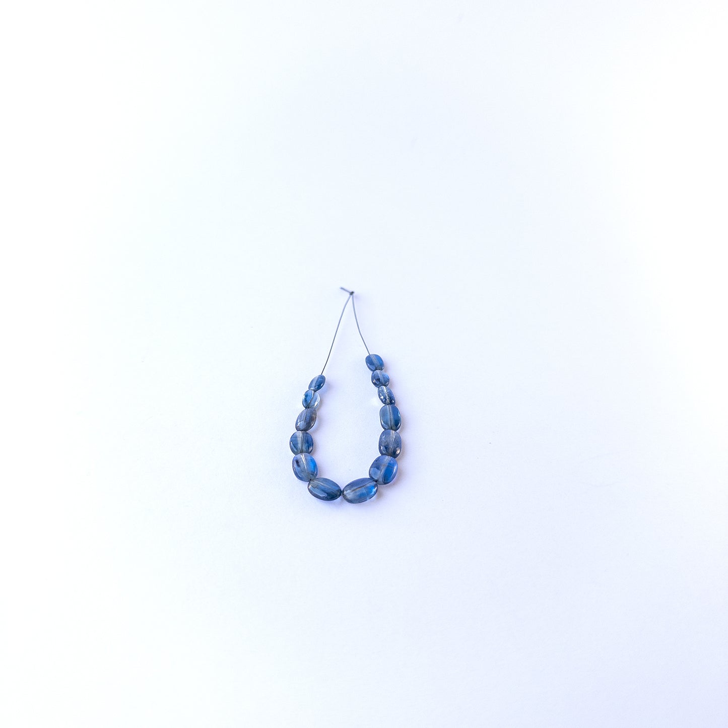 Kyanite smooth oval gemstone beads in 4.7–6.2mm sizes, showcasing deep blue tones for handmade jewellery designs.