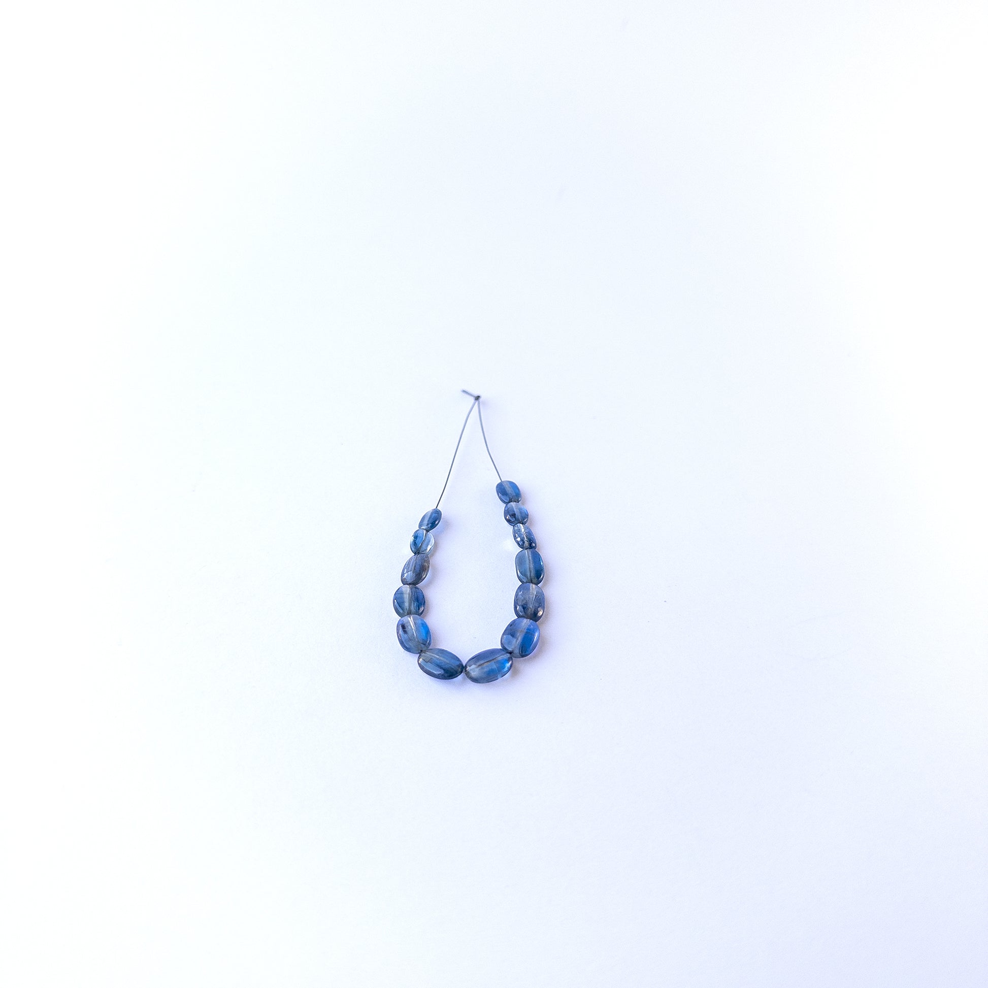 Kyanite smooth oval gemstone beads in 4.7–6.2mm sizes, showcasing deep blue tones for handmade jewellery designs.