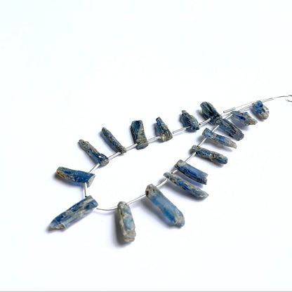 Raw kyanite pieces displayed with visible striations ideal for natural gemstone beads in jewellery making.