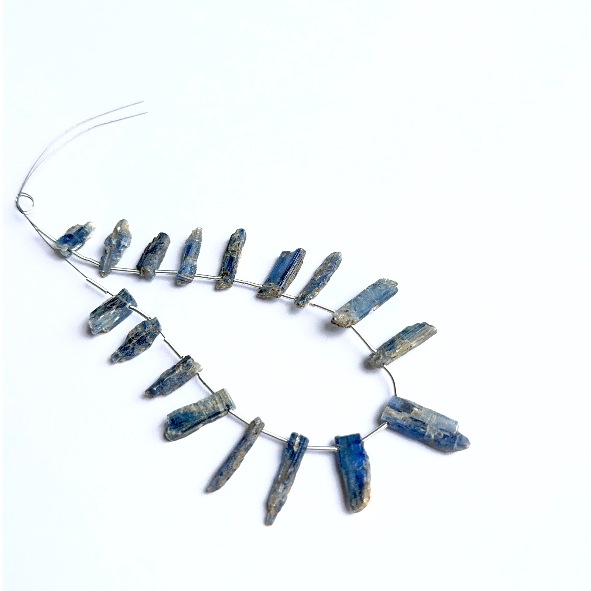 Kyanite rough stones arranged neatly to showcase natural gemstone quality and handcrafted appeal.