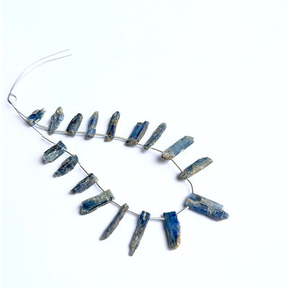 Kyanite rough stones arranged neatly to showcase natural gemstone quality and handcrafted appeal.