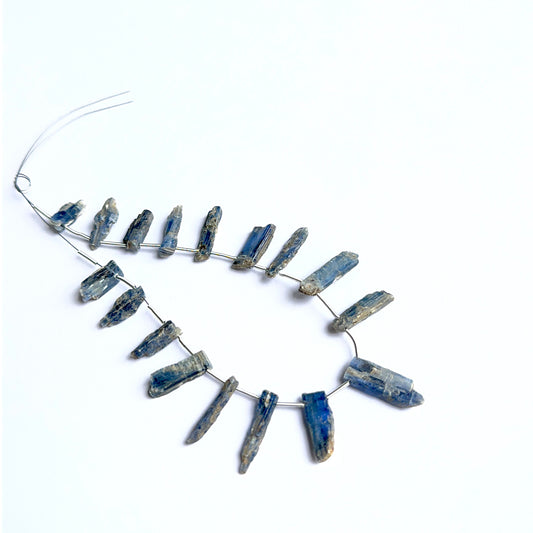 Kyanite rough stones arranged neatly to showcase natural gemstone quality and handcrafted appeal.