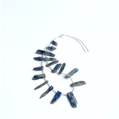 Kyanite rough stones photographed to show their unpolished finish and suitability for handmade jewellery components.