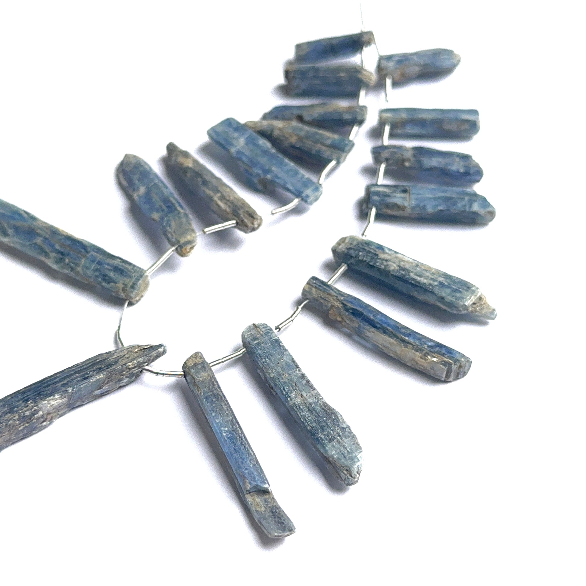 Close‑up of kyanite rough stone beads highlighting their organic shape and layered blue colour for DIY jewellery.