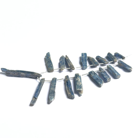 Kyanite rough beads arranged neatly to showcase natural gemstone quality and handcrafted appeal.
