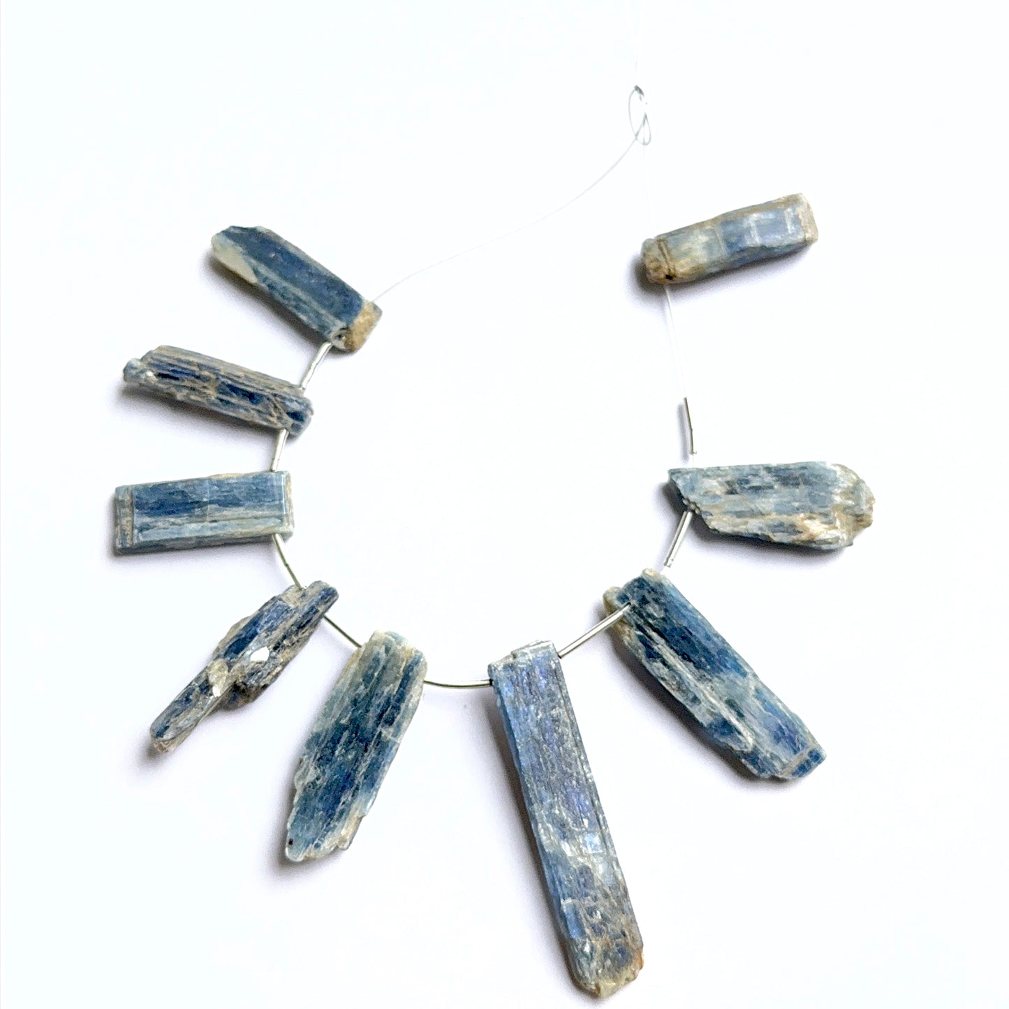 Kyanite rough stones arranged neatly to showcase natural gemstone quality and handcrafted appeal.