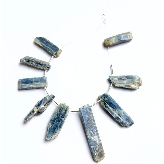 Kyanite rough stones arranged neatly to showcase natural gemstone quality and handcrafted appeal.