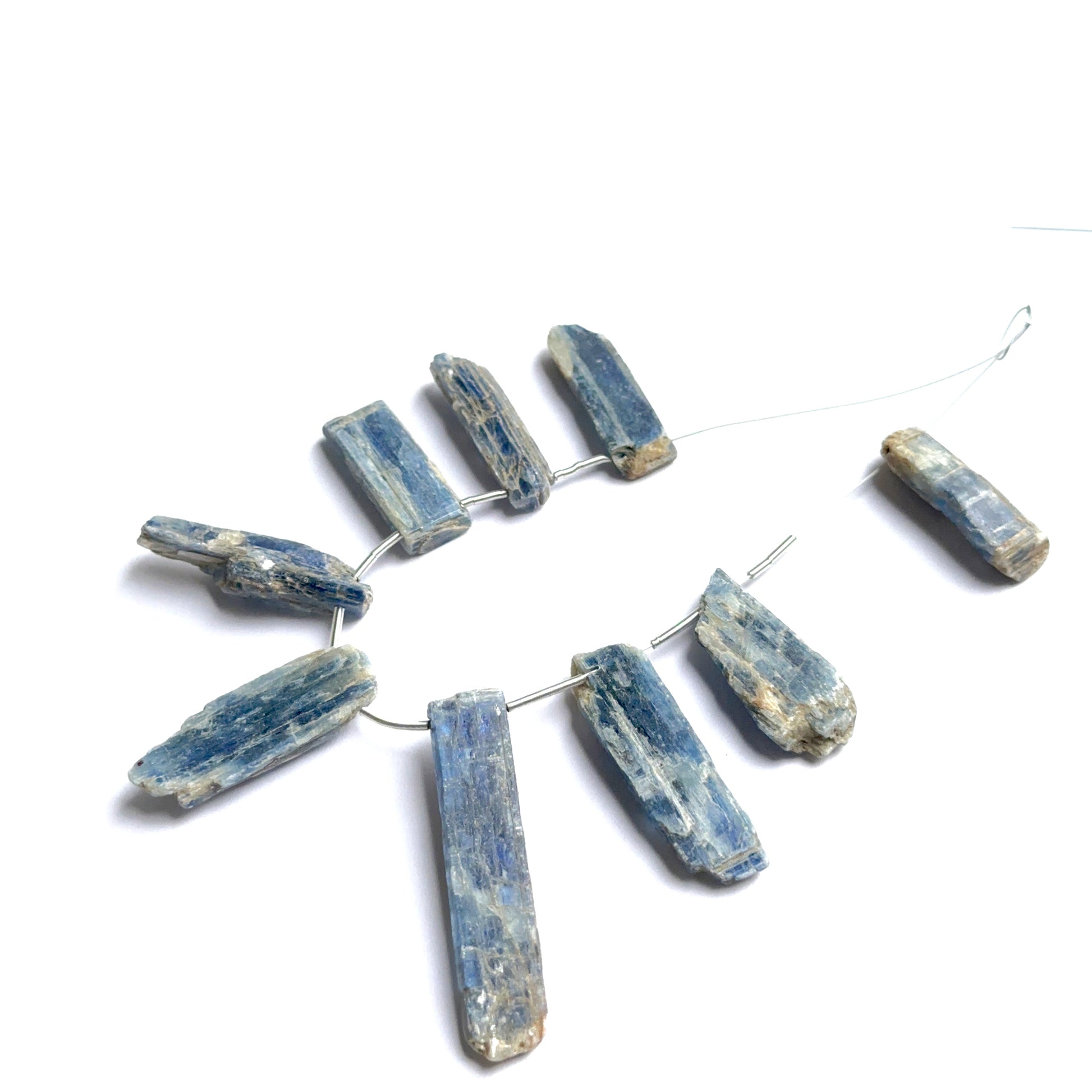 Raw kyanite pieces displayed with visible striations ideal for natural gemstone beads in jewellery making.