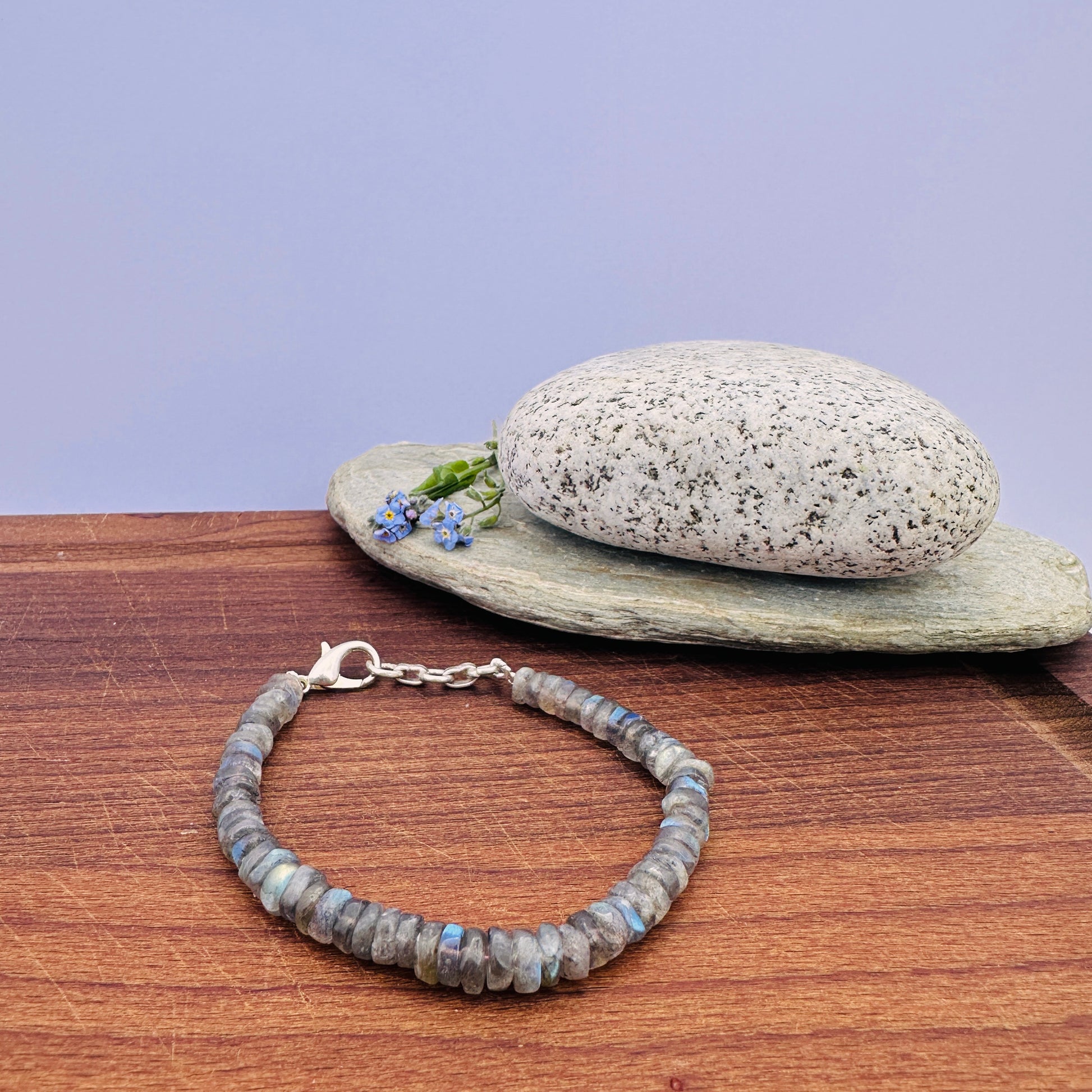 Labradorite bracelet with smooth wheel-cut beads in shimmering grey-blue tones.