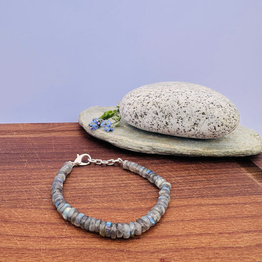 Labradorite bracelet with smooth wheel-cut beads in shimmering grey-blue tones.