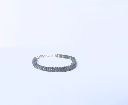Close-up of natural gemstone beads in a Labradorite bracelet with polished finish.