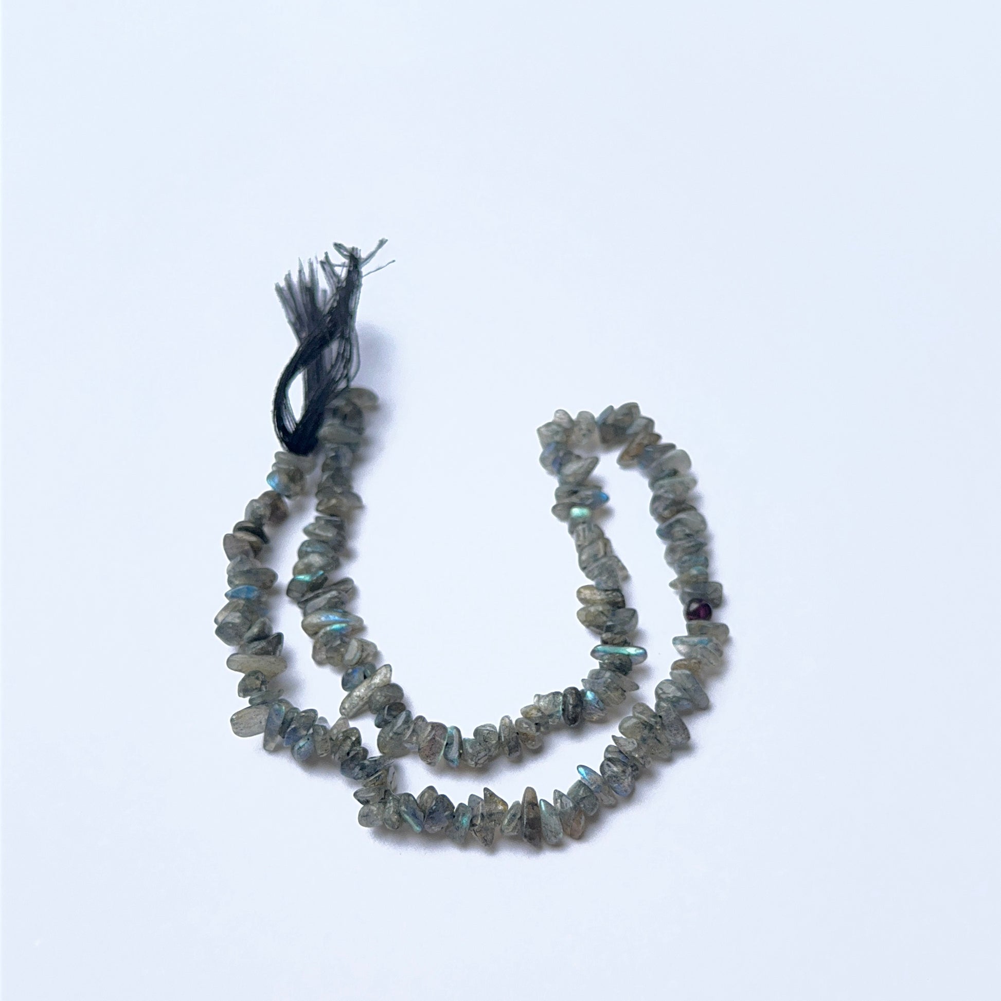 Close‑up of Labradorite stone beads in chip cut, highlighting iridescent shimmer and organic texture for handmade jewellery components.